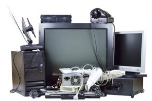 Pile of old and used TVs, computers, and other electronics