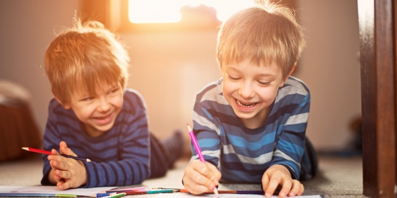 Two boys drawing pictures